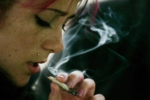 A young woman smokes marijuana before the 10th annual Marijuana March in downtown Toronto